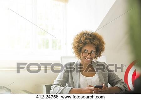 Portrait of smiling office worker with smart phone View Large Photo Image Stock Photograph - Portrait of smiling office worker with smart phone. Fotosearch