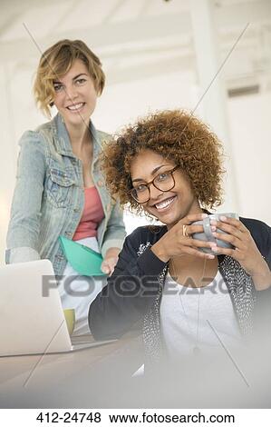 Stock Photo - Portrait of two smiling office workers. Fotosearch