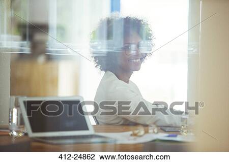 Stock Image - Portrait of young smiling office worker. Fotosearch
