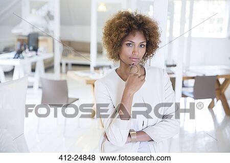 Stock Photo - Portrait of young smiling office worker. Fotosearch