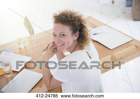 Portrait of young smiling office worker at desk View Large Photo Image Stock Photography - Portrait of young smiling office worker at desk. Fotosearch