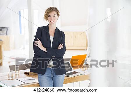 Portrait of young woman at office View Large Photo Image Stock Image - Portrait of young woman at office. Fotosearch