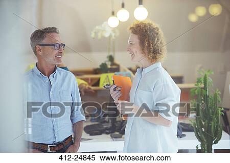 Three office workers talking at office View Large Photo Image Stock Photography - Three office workers talking at office. Fotosearch