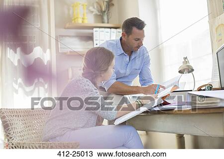 Father helping teenage daughter with her homework View Large Photo Image Stock Image - Father helping teenage daughter with her homework. Fotosearch