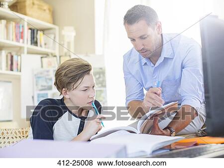 Father helping teenage son with his homework View Large Photo Image Stock Photo - Father helping teenage son with his homework. Fotosearch