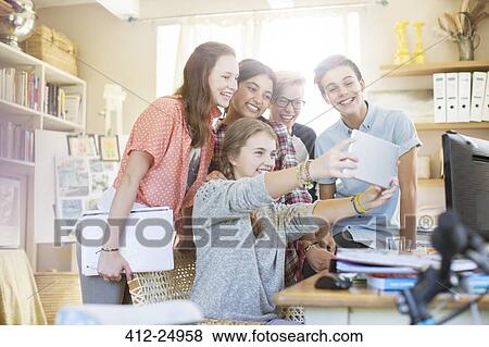 Group of teenagers taking selfie with digital tablet View Large Photo Image Stock Photo - Group of teenagers taking selfie with digital tablet. Fotosearch
