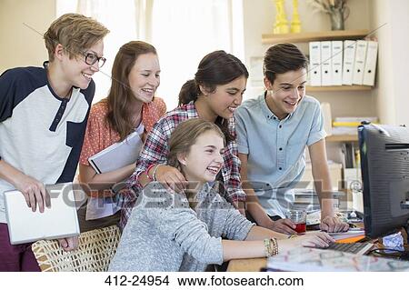 Group of teenagers using together computer in room View Large Photo Image Picture - Group of teenagers using together computer in room. Fotosearch
