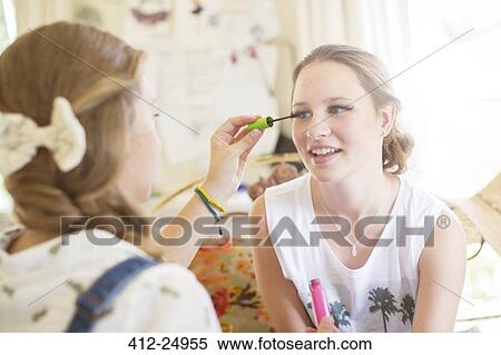 Teenage girls doing eye make up View Large Photo Image Stock Photography - Teenage girls doing eye make up. Fotosearch