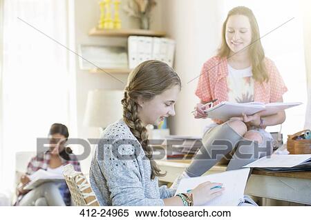 Three teenage girls doing homework in room View Large Photo Image Stock Photography - Three teenage girls doing homework in room. Fotosearch