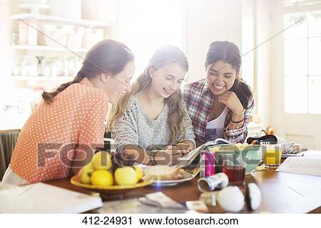 Three teenage girls learning at table in dining room View Large Photo Image Stock Image - Three teenage girls learning at table in dining room. Fotosearch