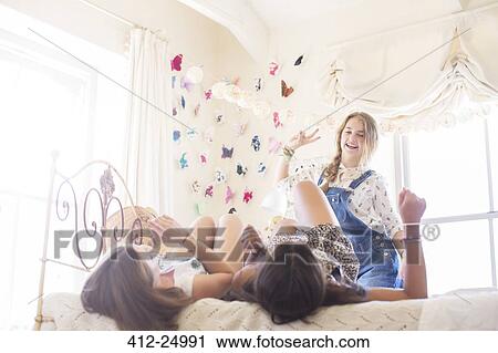 Three teenage girls playing in bedroom View Large Photo Image Stock Image - Three teenage girls playing in bedroom. Fotosearch