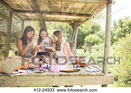 Three teenage girls playing in tree house in summer View Large Photo Image Stock Image - Three teenage girls playing in tree house in summer. Fotosearch