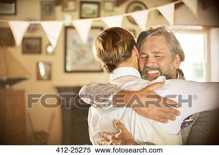 Best man embracing bridegroom in domestic room View Large Photo Image Stock Photography - Best man embracing bridegroom in domestic room. Fotosearch