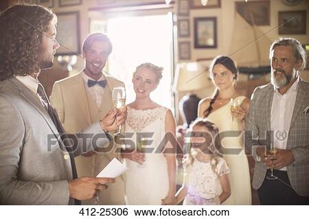 Best man toasting with champagne and giving speech during wedding reception in domestic room View Large Photo Image Stock Photograph - Best man toasting with champagne and giving speech during wedding reception in domestic room. Fotosearch