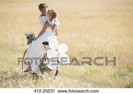Bride and bridegroom riding bike with balloons attached View Large Photo Image Stock Image - Bride and bridegroom riding bike with balloons attached. Fotosearch