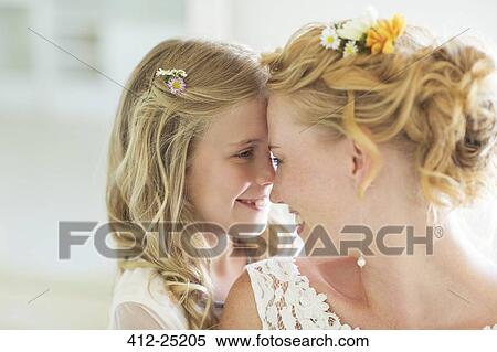 Bride and bridesmaid facing each other smiling View Large Photo Image Stock Photography - Bride and bridesmaid facing each other smiling. Fotosearch