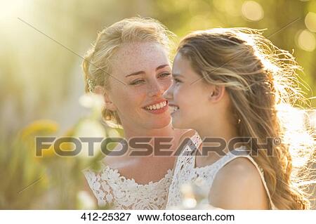 Bride talking to Bridesmaid in domestic garden View Large Photo Image Stock Photo - Bride talking to Bridesmaid in domestic garden. Fotosearch