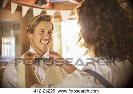 Stock Photograph - Bridegroom and best man preparing for wedding ceremony. Fotosearch