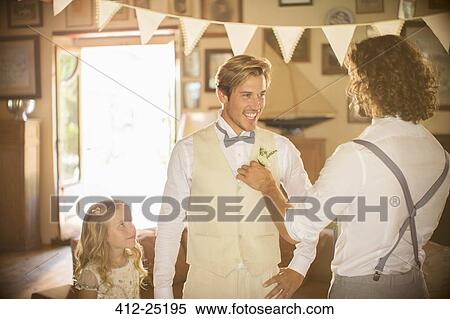 Stock Photography - Bridegroom and best man preparing for wedding ceremony. Fotosearch