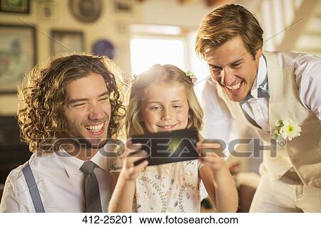 Bridegroom and best man withbridesmaid photographing self in domestic room View Large Photo Image Stock Image - Bridegroom and best man withbridesmaid photographing self in domestic room. Fotosearch