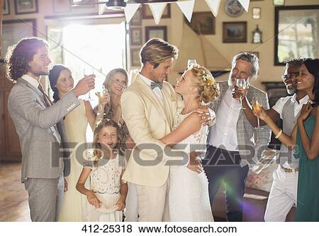 Bridegroom embracing bride during wedding reception in domestic room View Large Photo Image Stock Photo - Bridegroom embracing bride during wedding reception in domestic room. Fotosearch