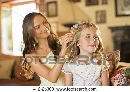Bridesmaid helping girl with hairstyle in domestic room View Large Photo Image Stock Image - Bridesmaid helping girl with hairstyle in domestic room. Fotosearch