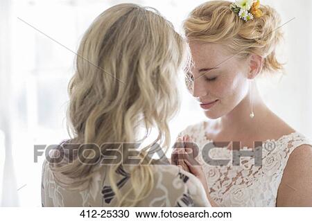 Matron of honor and bride talking in domestic room View Large Photo Image Stock Image - Matron of honor and bride talking in domestic room. Fotosearch