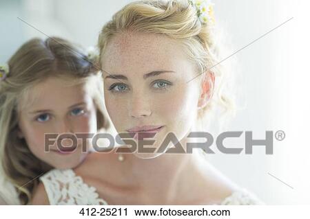 Stock Image - Portrait of bride and bridesmaid looking at camera. Fotosearch