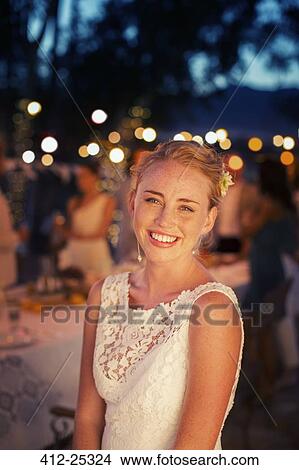 Picture - Portrait of bride in garden at dusk. Fotosearch