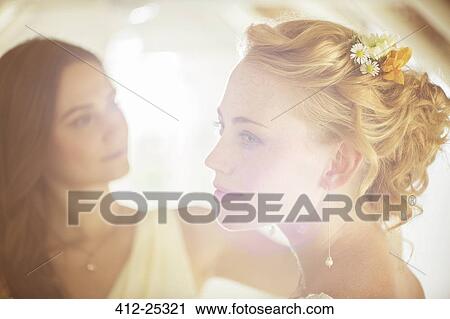 "Portrait of bride with bridesmaid in background in domestic room View Large Photo Image Stock Image - "Portrait of bride with bridesmaid in background in domestic room. Fotosearch