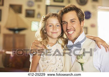 Portrait of bridegroom and bridesmaid in domestic room View Large Photo Image Stock Photo - Portrait of bridegroom and bridesmaid in domestic room. Fotosearch