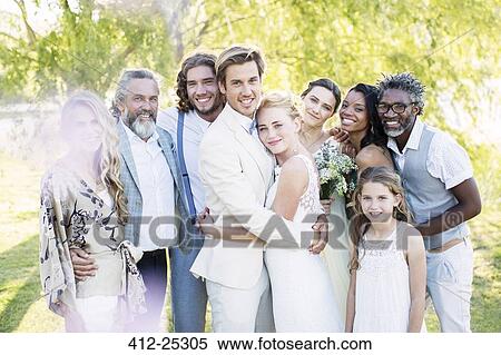 Stock Photography - Portrait of young couple and guests during wedding ceremony. Fotosearch