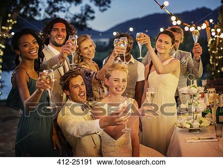 Wedding guests toasting with champagne during wedding reception in garden View Large Photo Image Stock Image - Wedding guests toasting with champagne during wedding reception in garden. Fotosearch