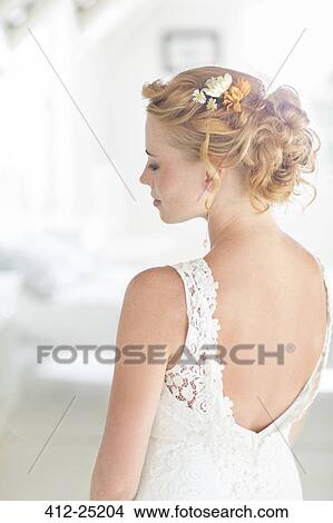 Young bride standing in sunny bedroom View Large Photo Image Picture - Young bride standing in sunny bedroom. Fotosearch