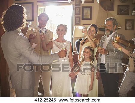 Young couple and guests toasting with champagne at wedding reception View Large Photo Image Stock Photography - Young couple and guests toasting with champagne at wedding reception. Fotosearch