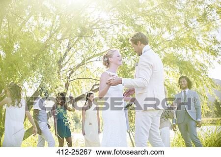 Stock Photo - Young couple dancing at wedding reception in domestic garden. Fotosearch