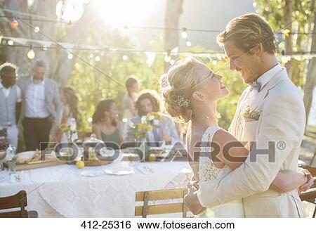 Young couple dancing during wedding reception in domestic garden View Large Photo Image Stock Photograph - Young couple dancing during wedding reception in domestic garden. Fotosearch