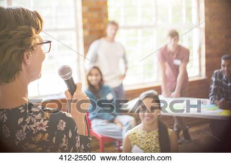 Stock Image - Audience listening to speaker at community center. Fotosearch