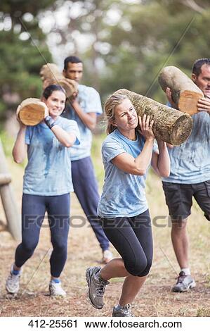 Determined people running with logs on boot camp obstacle course View Large Photo Image Stock Image - Determined people running with logs on boot camp obstacle course. Fotosearch