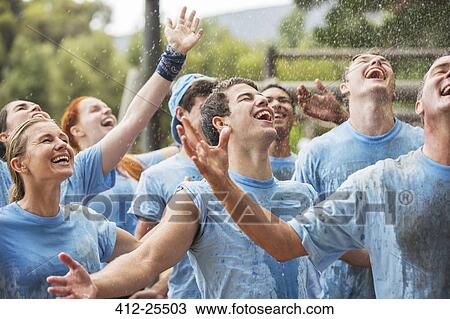Enthusiastic team enjoying rain at boot camp View Large Photo Image Stock Image - Enthusiastic team enjoying rain at boot camp. Fotosearch