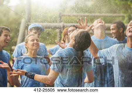 Enthusiastic team enjoying rain at boot camp View Large Photo Image Stock Photography - Enthusiastic team enjoying rain at boot camp. Fotosearch