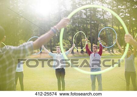 Picture - Group connected in circle by plastic hoops. Fotosearch