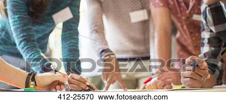 Stock Image - Hands of creative business people brainstorming in meeting. Fotosearch