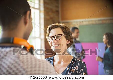 Stock Photograph - People talking at community center. Fotosearch