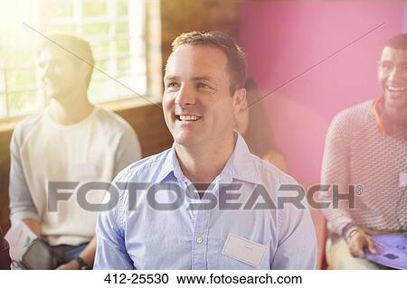 Smiling man in audience View Large Photo Image Stock Image - Smiling man in audience. Fotosearch