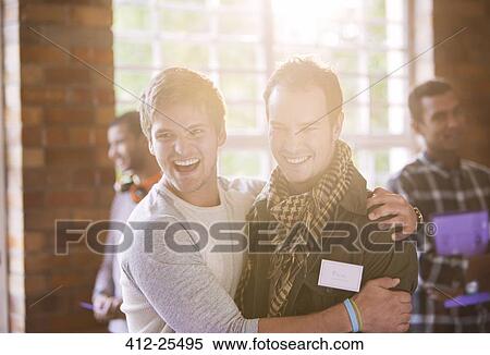 Smiling men hugging at seminar View Large Photo Image Stock Photography - Smiling men hugging at seminar. Fotosearch