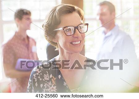 Stock Image - Smiling woman looking away. Fotosearch