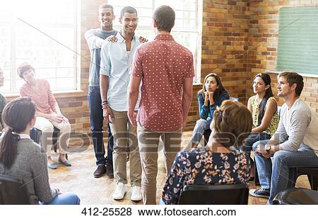Supportive men at group therapy session View Large Photo Image Stock Photo - Supportive men at group therapy session. Fotosearch