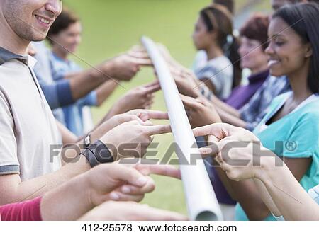 Stock Photo - Team balancing pole with fingertips. Fotosearch