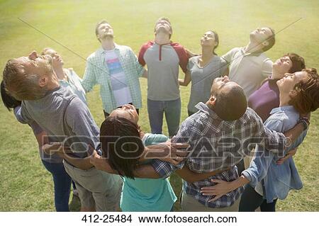 Team forming connected circle basking in sunny field View Large Photo Image Picture - Team forming connected circle basking in sunny field. Fotosearch
